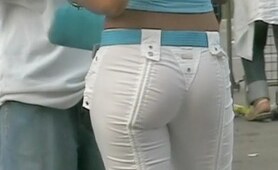 The charming bimbo in the denim hot pants of the white color was spied in the streets