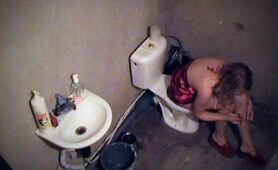 Girl smoking on toilet in voyeur movie
